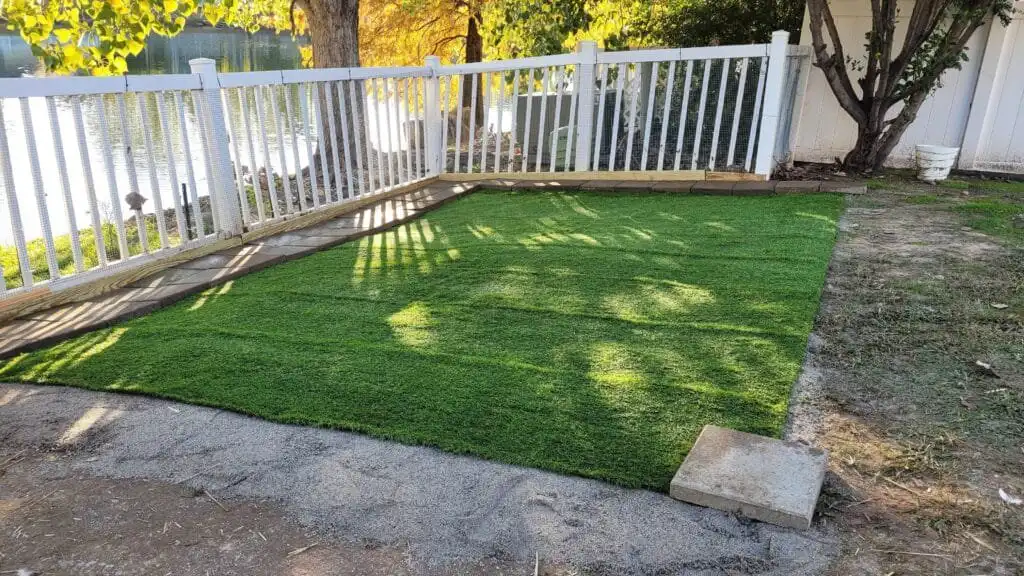 installing artificial turf for the duck run